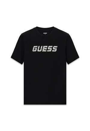 Zwart katoenen t-shirt met een groot, gestructureerd wit "GUESS"-logo over de borst. Korte mouwen en een ronde hals.