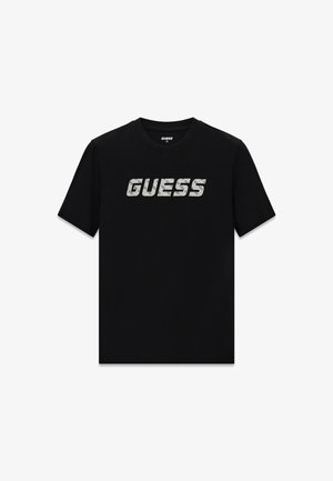 Czarny bawełniany t-shirt z dużym, teksturowanym białym logo "GUESS" na klatce piersiowej. Krótkie rękawy oraz okrągły dekolt.