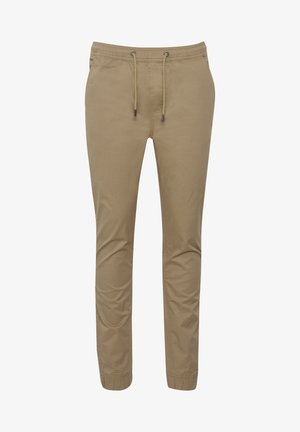 Rövidnadrág bézs színben, puha anyagból készült, rugalmas derékkal és húzózsinórral, valamint szűkülő lábnyílásokkal. Sima textúrájú, minta nélkül.