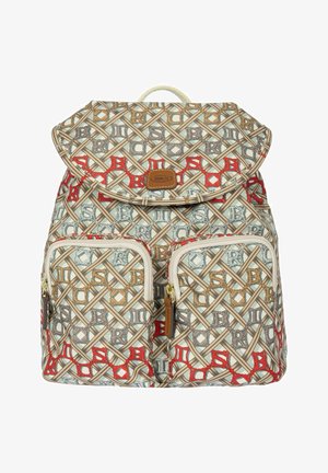 Sac à dos avec motif géométrique beige, rouge et bleu, deux poches avant zippées, fermeture à rabat et poignée supérieure.