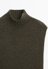 Dark green knit turtleneck sweater with ribbed collar and shoulder seams, made from a soft wool blend fabric. Smooth texture overall.