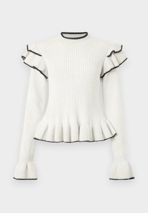 Suéter blanco con ribetes negros en los hombros y puños acampanados, con un dobladillo en volantes y cuello redondo.