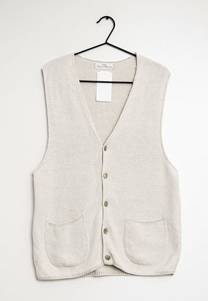 Beige strikket cardigan med V-hals, seks knaplukninger og to forlommer. Stoffet har et tekstureret mønster og en blød fremtoning.