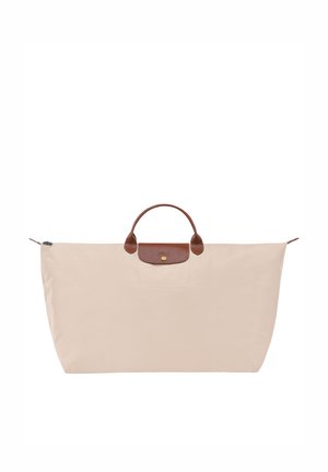 Beige nylon tote bag with a rounded brown leather handle, gold hardware, and a subtle front pocket. Features a zip closure at the top.