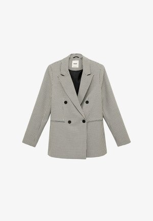 Blazer de mujer cruzado con patrón de cuadros en blanco y negro, solapas con muesca, cuatro botones negros y dos bolsillos delanteros.
