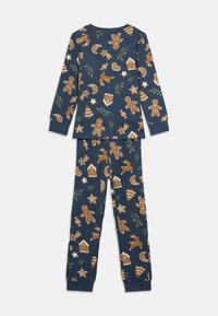 Σετ πιτζάμας από βαμβάκι με ναυτικό φόντο και πολύχρωμα σχέδια με μπισκότα τζίντζερ και χριστουγεννιάτικα θέματα. Μακριά μανίκια και ταιριαστά παντελόνια.