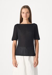 Black, short-sleeve top with a wide neckline. Made from lightweight, textured fabric. Smooth silhouette with a slightly loose fit.