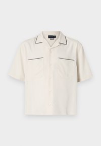 Short-sleeve beige shirt with black piping along the collar and pocket edges. Features two front pockets and a button-down closure.