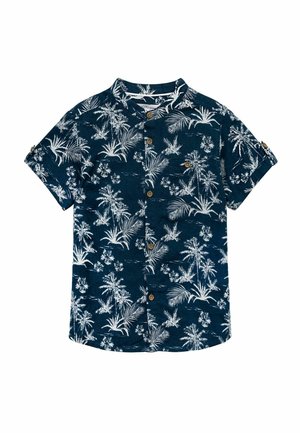 Chemise bleu marine à manches courtes boutonnée avec imprimé tropical blanc de palmiers et de fleurs et une petite poche poitrine.