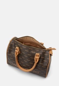 Brown handbag featuring a logo pattern, tan leather handles, zipper closure, and a spacious interior with a pocket.