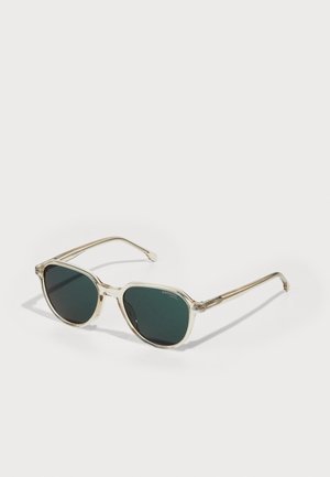 Ochelari de soare cu o ramă clară, geometrică, lentile verzi închise și accente metalice pe brațe. Formă ovală clasică și design ușor.