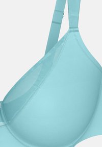 Light blue bra featuring smooth cups, adjustable straps, and a textured accent on the upper edge. Seamless design with soft fabric.