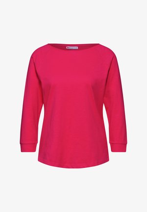 Růžový dlouhý rukáv s širokým výstřihem, raglánovými rukávy a volným střihem. Hladká textura bez viditelných vzorů nebo kovových prvků.