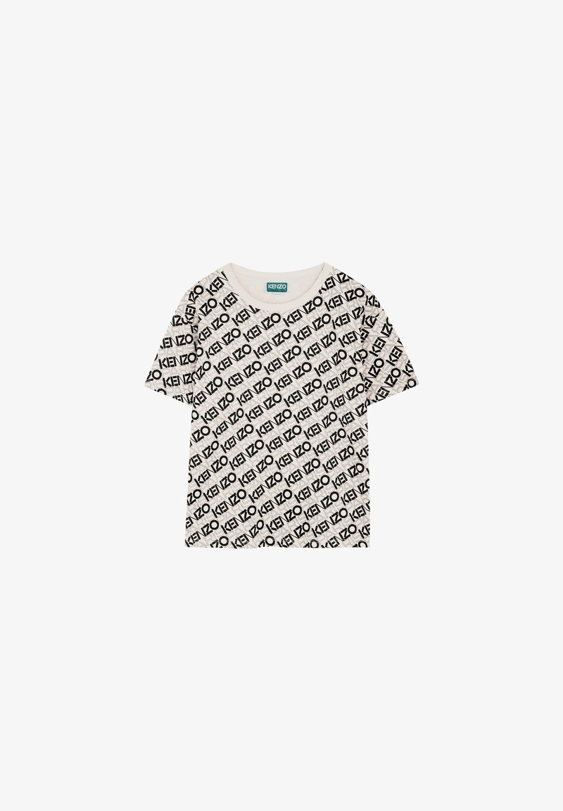 T-shirt à manches courtes, col rond en beige clair avec un motif imprimé répétitif de logo noir. Matière en coton doux avec une coupe décontractée.