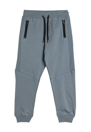 Grijze joggerbroeken met ribbelstructuur, elastische tailleband en verstelbaar zwart trekkoord. Voorzien van twee met rits afgesloten zakken aan de voorkant.