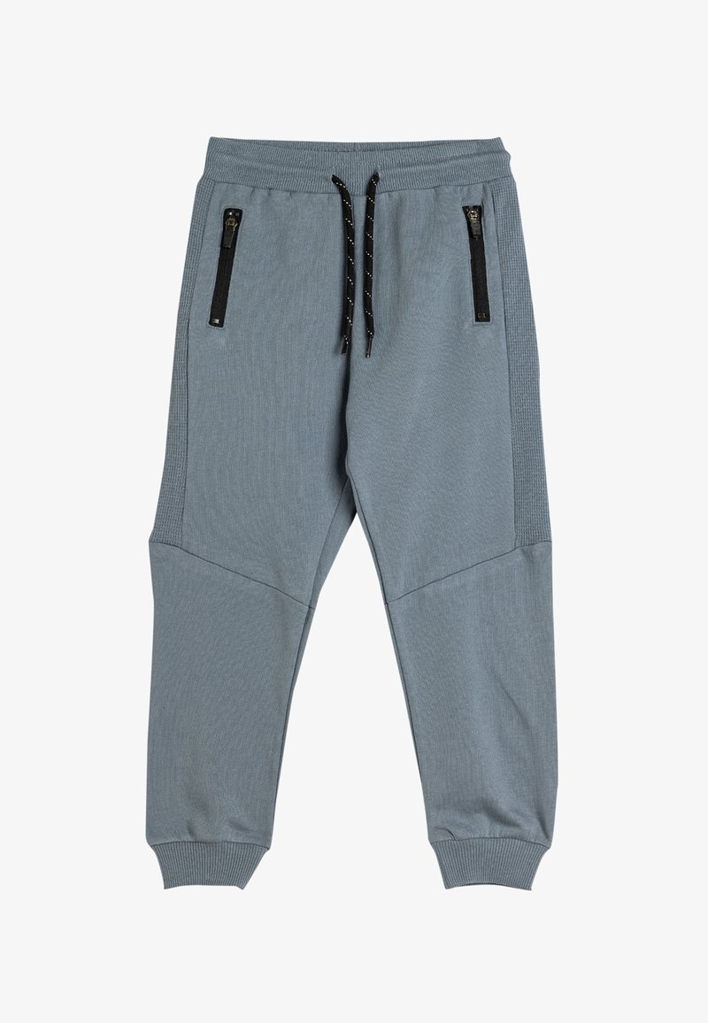 Grijze joggerbroeken met ribbelstructuur, elastische tailleband en verstelbaar zwart trekkoord. Voorzien van twee met rits afgesloten zakken aan de voorkant.