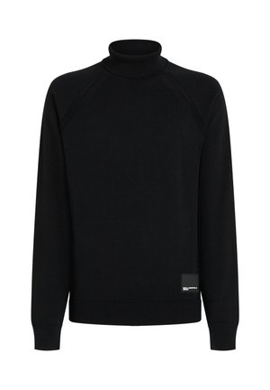 Pull noir à col roulé manches longues avec col, poignets et bas côtelés, avec une petite étiquette noire rectangulaire en bas devant à droite.