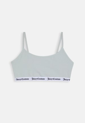 Heledhalli bralette, millel on õhukesed reguleeritavad rihmad ja valgest elastne vöö, millel on mustades tähtedes brändinimi "Juicy Couture".