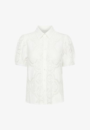 Valkoinen lyhythihainen paita, jossa on pitsikuvioita pyöreillä kuvioilla, nappi etuosassa ja perinteinen kaulus.