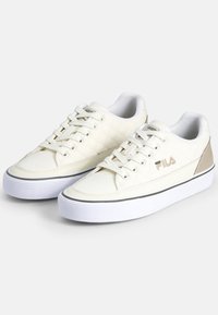 Sneakers bianche trapuntate con punta tonda, design con lacci, upper testurizzato e accenti beige a contrasto. Suola intermedia spessa bianca con striscia nera.