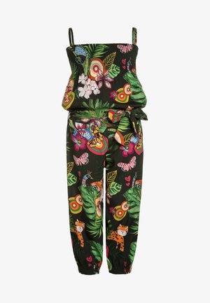 Combinaison avec bretelles, haut et chevilles élastiqués, taille nouée, base noire, imprimés tropicaux colorés de fleurs, feuilles, papillons et animaux.