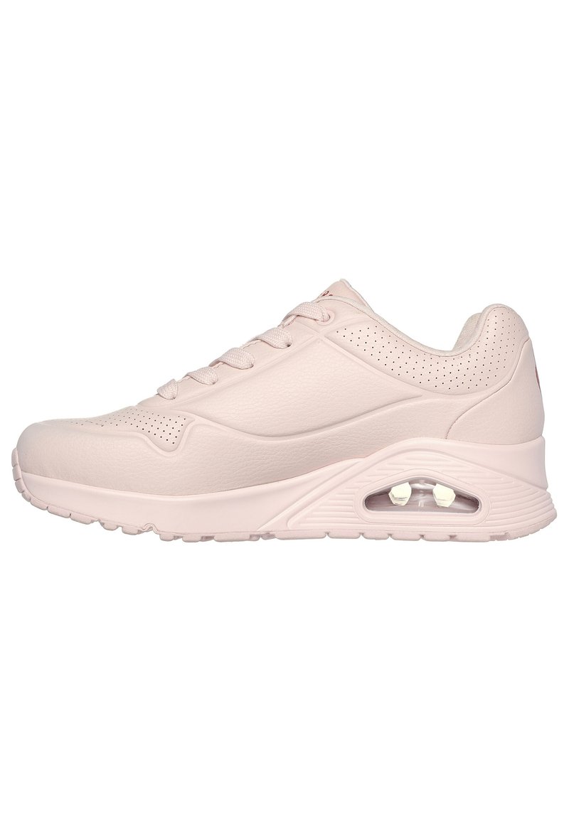 Pink athletic shoe with a smooth leather upper, perforated details, lace-up design, and a visible air cushioning unit in the sole.