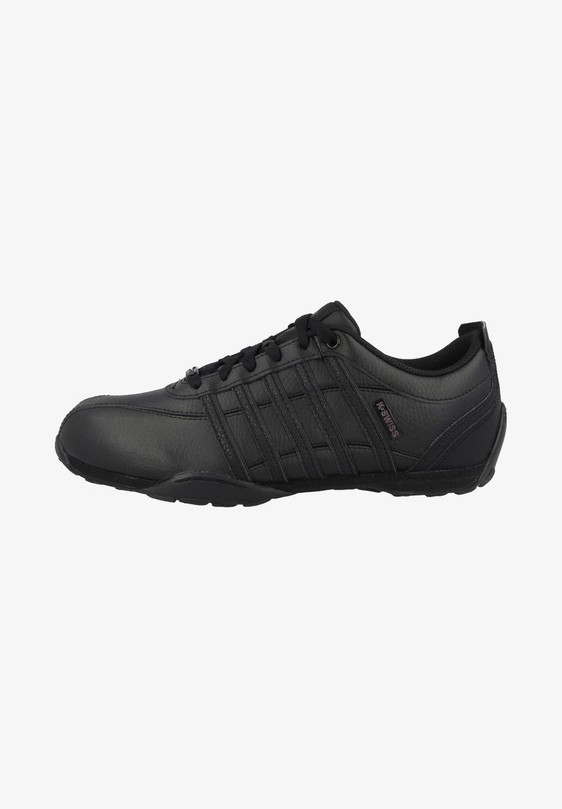 Black athletic shoe made of smooth leather with a rounded toe, lace-up design, padded collar, and multiple parallel stripes on the sides.