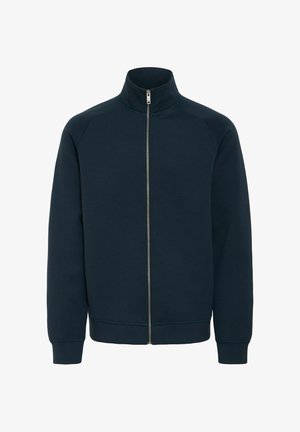 Sötétkék, cipzáros pulóver magas gallérral, bordázott mandzsettával és alsó résszel, puha, texturált anyagból készült. Elöl cipzáros záródással rendelkezik.