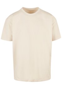 Beige crew neck t-shirt made of soft cotton fabric; short sleeves and relaxed fit; smooth texture with no patterns or prints.