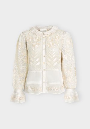 White long-sleeve blouse with floral embroidery, sheer patterned fabric, ruffled collar and cuffs, front button closure, and delicate lace details.
