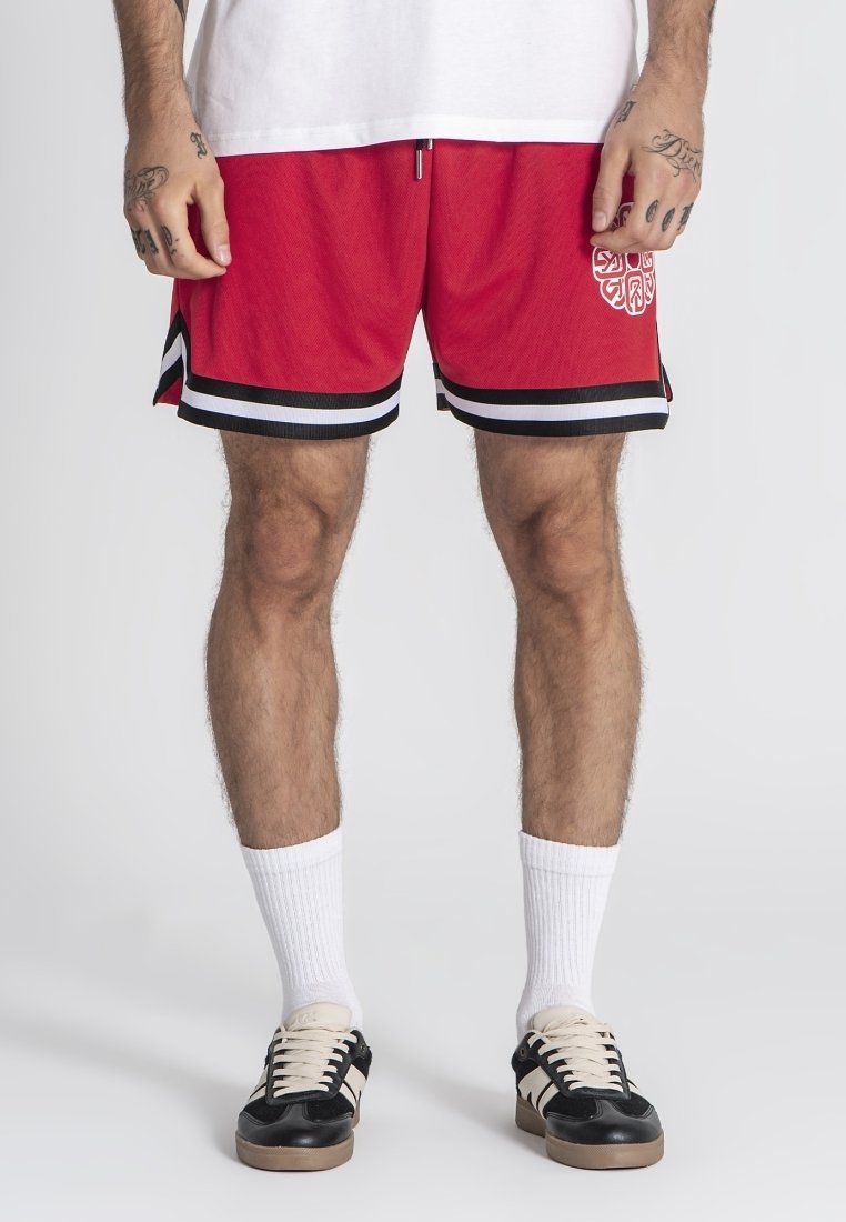 Czerwone spodenki sportowe z czarno-białymi paskami, wykonane z teksturowanej tkaniny, z dekoracyjnym białym logo po lewej stronie.