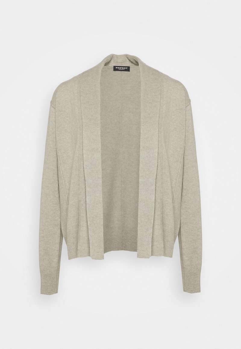 Světle béžový cardigan vyrobený z měkkého materiálu, s pružným otevřeným předním dílem, dlouhými rukávy a uvolněným střihem bez zapínání.