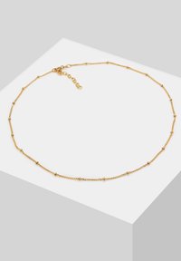 Gold chain necklace with small round beads spaced along the length. Features a lobster clasp and adjustable chain extension.