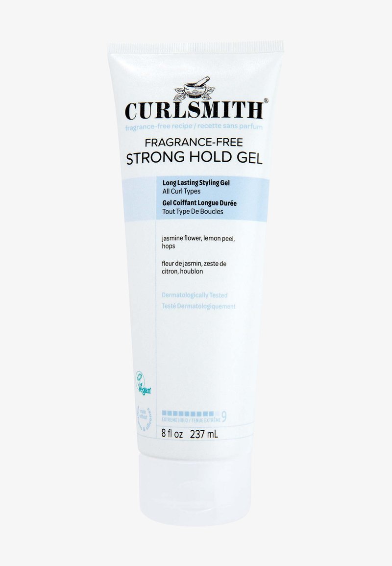 Gel per capelli a forte tenuta senza profumo di Curlsmith in un tubetto bianco da 237 mL. Presenta testo blu, etichetta testata dermatologicamente e simbolo vegano.