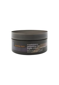 Conteneur rond noir de la pâte coiffante Aveda Men avec une finition mate, comportant un logo orange, une bande texturée et une description du produit en mode bilingue.