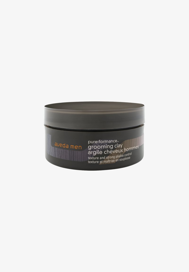 Schwarzer runder Behälter von Aveda Men Grooming Clay mit matter Oberfläche, ausgestattet mit einem orangefarbenen Logo, strukturiertem Band und zweisprachiger Produktbeschreibung.