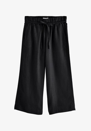 Pantalon noir à jambes larges et coupé au-dessus de la cheville, avec taille élastique et cordon noué, doté de poches latérales.