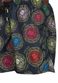 Zwemshorts van zwart synthetisch materiaal met kleurrijke leeuwenkop patronen in cirkelvormige kaders, voorzien van een trekkoord in de taille en zijzakken.