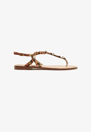 Brown flat sandal with ankle strap, decorated with small multicolored stones and shell embellishments on thin straps.