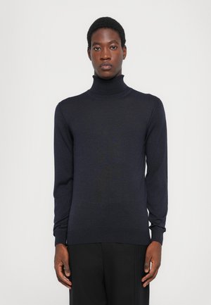 Tumed turtleneck-sweater, mis on valmistatud pehmest kudumist, omab pikki varrukaid ja sobivat lõiget, jäädes samas tagasihoidlikult tekstuurseks.