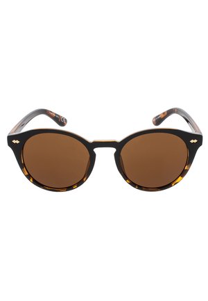 Gafas de sol de acetato carey en forma de ojo de gato con lentes marrones y un acabado brillante. Presentan patillas elegantes y curvadas. Con un pequeño logotipo en el costado.