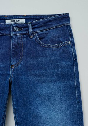 Denim jeans in dark blue, featuring a front button closure, belt loops, and side pockets; brand label reads "Salsa Jeans."