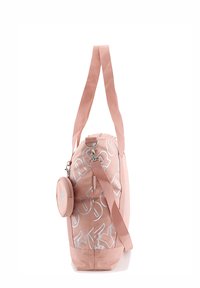 Pink duffel bag with white text, featuring a detachable circular pouch, sturdy straps, and a smooth, matte exterior.