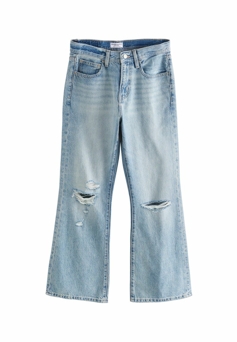 Lichtgewassen denim jeans met een uitlopende pijp, voorzien van versleten stukken en twee steekzakken. Eenvoudige stiksels. Geen zichtbare metalen onderdelen.