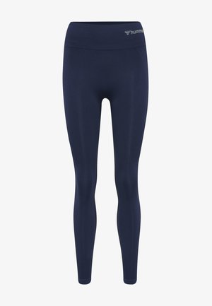 Mörkblå leggingar tillverkade av smidigt, elastiskt material med hög midja och en subtil logotyp nära toppen. Inga mönster eller metalldelar synliga.