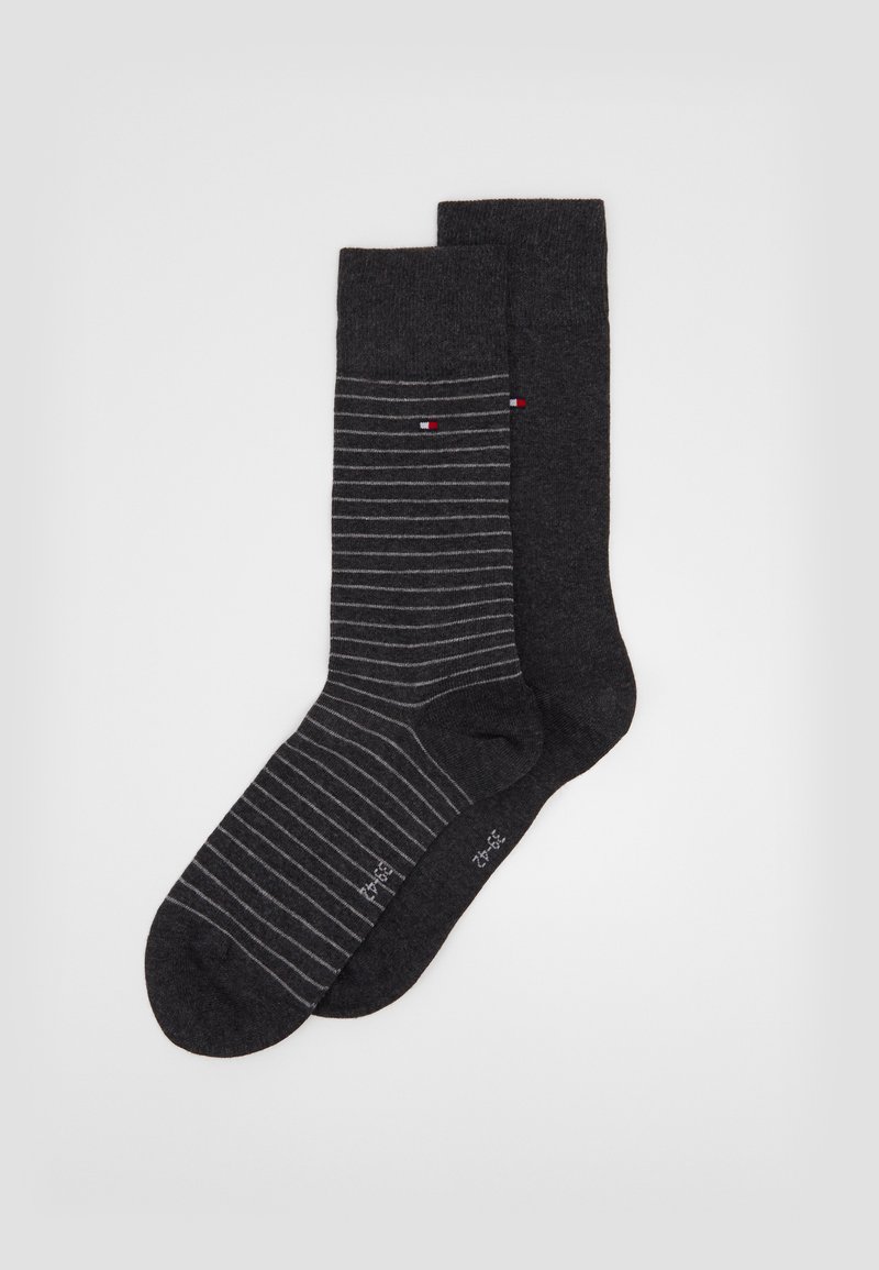 Dark gray socks, one with gray stripes and a small logo, the other solid dark gray. Both have a smooth texture and a mid-calf design.
