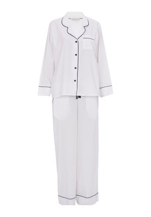 Weißes Seiden-Pyjama-Set mit schwarzem Piping. Das Shirt hat eine Tasche und Knöpfe, während die Hose eine lockere, gerade Passform hat.