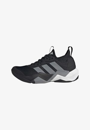 Black athletic shoe with a breathable mesh upper, grey accents, textured sole, and three distinctive stripes on the side.