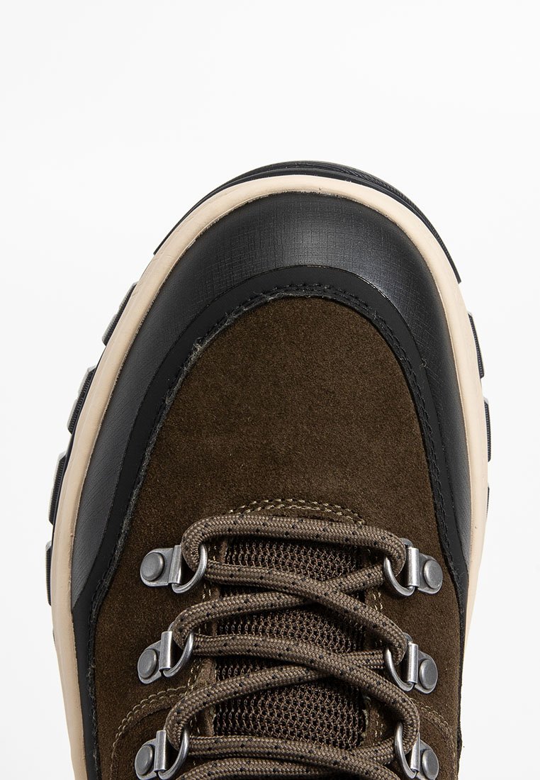 Braunes Wildleder-Wanderschuh mit einer schwarzen Gummikappe, beiger Zwischensohle, Metallösen und strukturierten Schnürsenkeln. Verfügt über ein robustes Design.