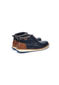 Men's ankle boots in dark blue leather with brown accents, round toe, contrasting beige midsole, and textured rubber outsole.